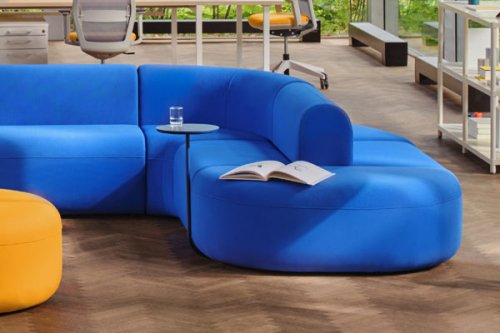 Modular sofa in a vibrant blue colour with built-in side tables